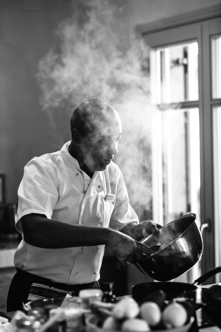 Chef Rory of BOND VIVEUR cooking — black and white portrait with steam rising from a pot.